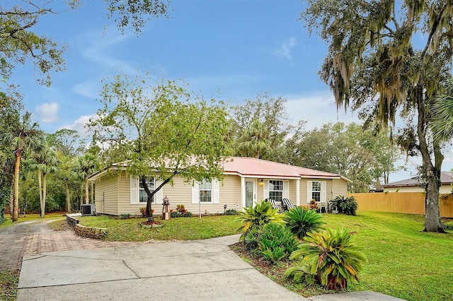 ranch-style house with a front lawn and cooling unit