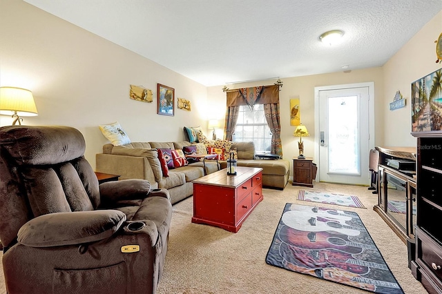 carpeted living room featuring a textured ceiling