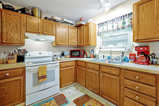 kitchen with sink, a textured ceiling, and white electric stove