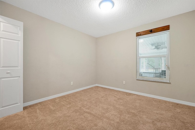 carpeted spare room with a textured ceiling