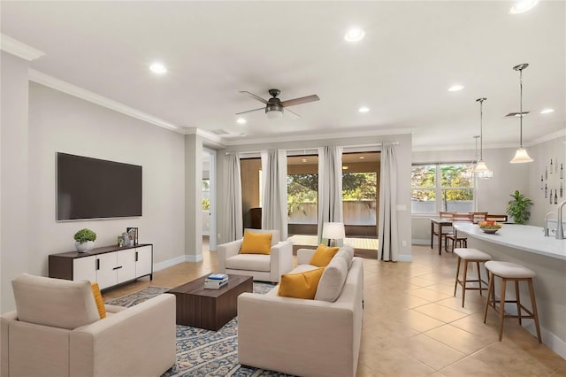 tiled living room with ceiling fan and crown molding