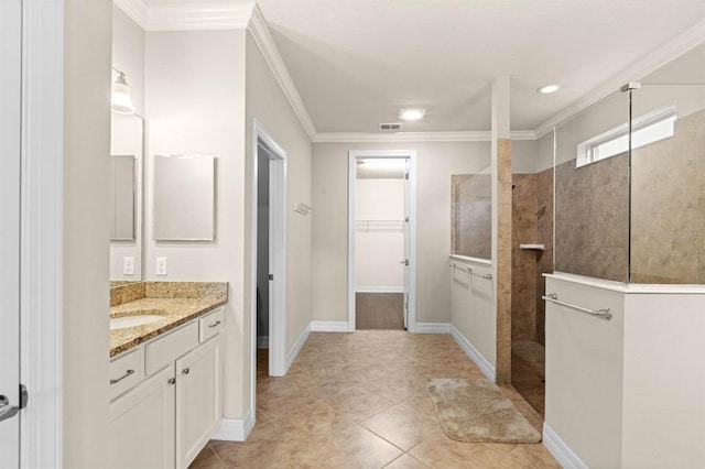 bathroom with tiled shower, vanity, tile patterned floors, and crown molding