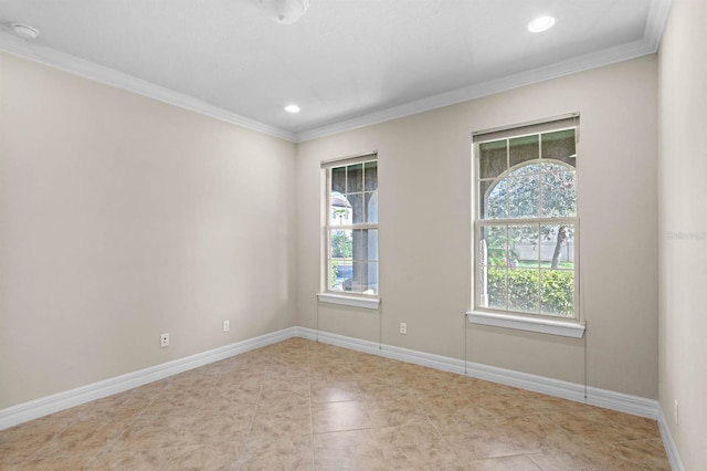 unfurnished room featuring light tile patterned floors and ornamental molding