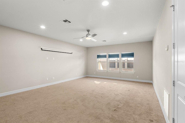 unfurnished room with light colored carpet and ceiling fan