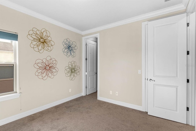 carpeted spare room featuring ornamental molding