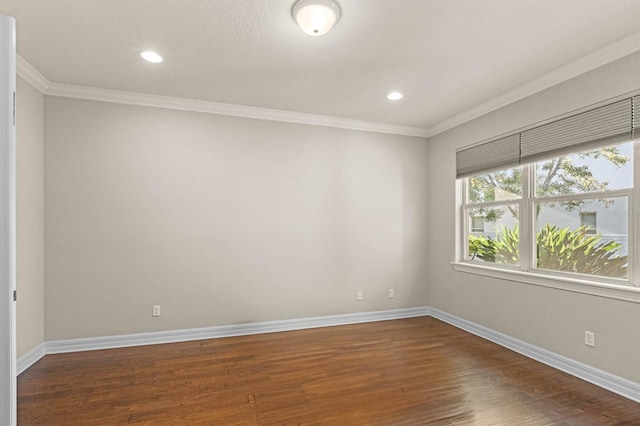 unfurnished room featuring dark hardwood / wood-style floors and ornamental molding