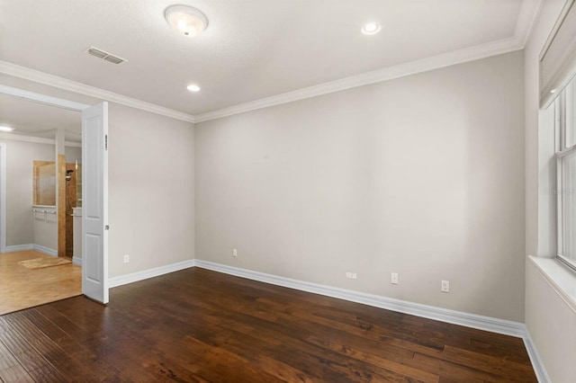 spare room with crown molding and dark hardwood / wood-style floors