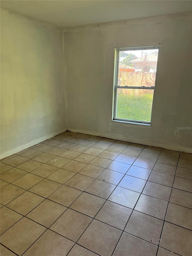 spare room with light tile patterned floors