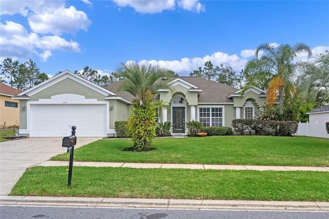 ranch-style home featuring a garage and a front lawn