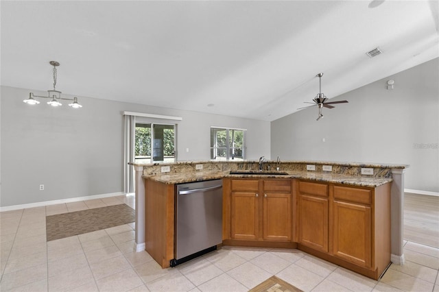 kitchen featuring sink, hanging light fixtures, stainless steel dishwasher, lofted ceiling, and a center island with sink