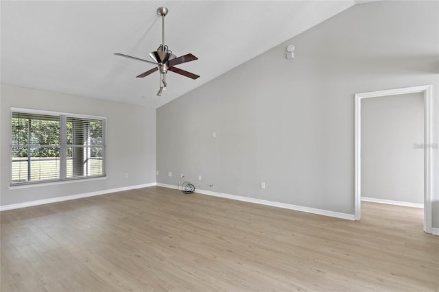 empty room featuring ceiling fan, light hardwood / wood-style flooring, and vaulted ceiling