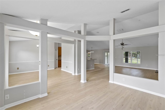 spare room featuring ceiling fan, light hardwood / wood-style flooring, and vaulted ceiling