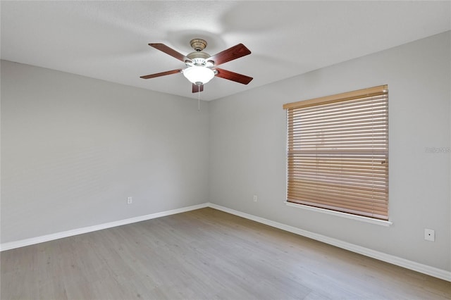 empty room featuring light hardwood / wood-style flooring and ceiling fan