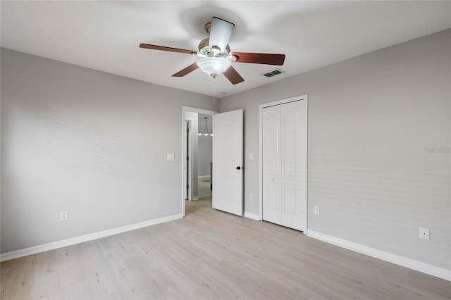 unfurnished bedroom with ceiling fan, a closet, and light hardwood / wood-style floors