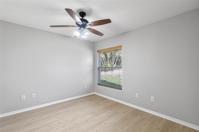 spare room with ceiling fan and light wood-type flooring