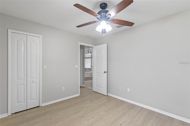 unfurnished bedroom featuring a closet, ceiling fan, and light hardwood / wood-style floors