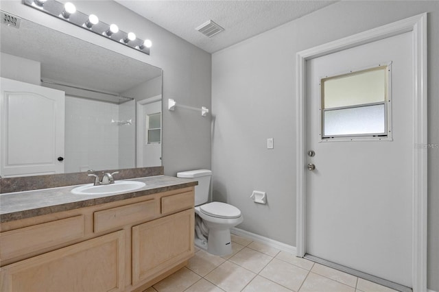 bathroom featuring walk in shower, tile patterned floors, a textured ceiling, toilet, and vanity