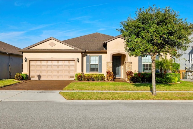 single story home featuring a front lawn and a garage