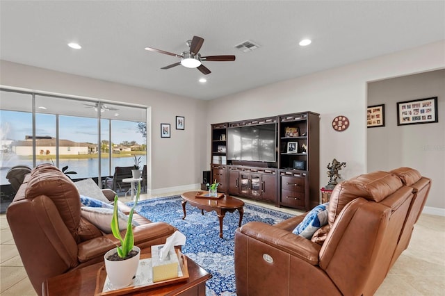 living room featuring light tile patterned floors and ceiling fan