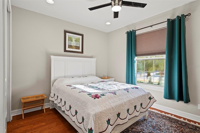 bedroom with ceiling fan and dark hardwood / wood-style floors