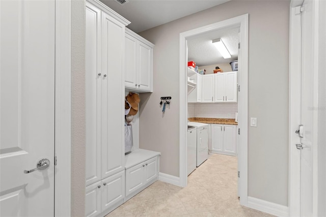 mudroom with washing machine and clothes dryer