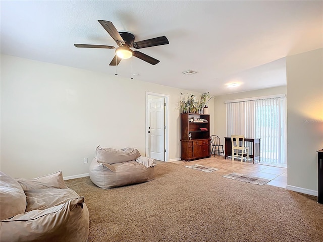 carpeted living room featuring ceiling fan