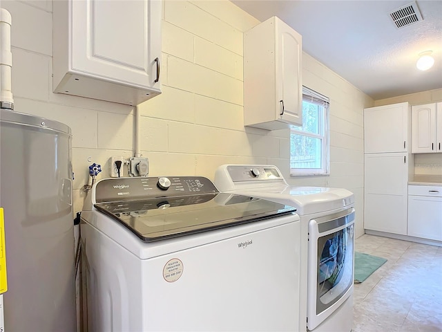 washroom with cabinets, independent washer and dryer, and water heater