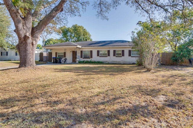 ranch-style home featuring a front yard