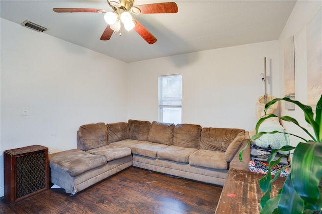 living room featuring ceiling fan and dark hardwood / wood-style floors