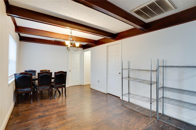 dining area with beam ceiling, dark hardwood / wood-style flooring, and an inviting chandelier