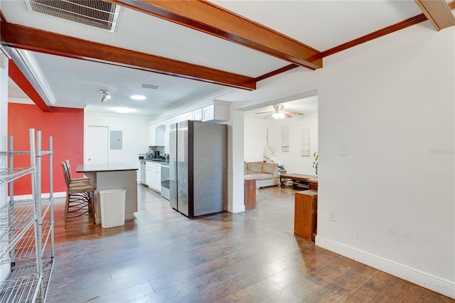 kitchen featuring white cabinetry, stainless steel fridge, a kitchen breakfast bar, electric panel, and a center island