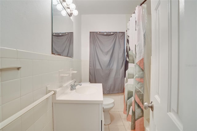 full bathroom with tile patterned floors, vanity, tile walls, toilet, and shower / tub combo with curtain