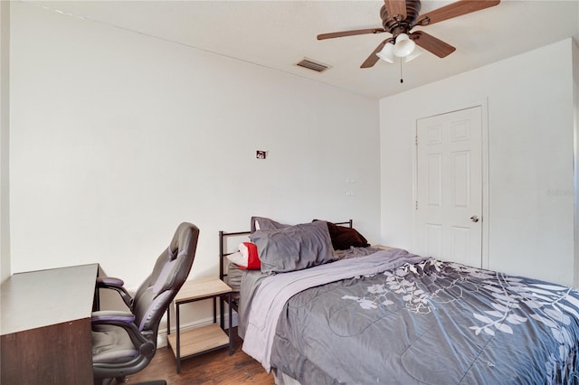 bedroom with ceiling fan and dark wood-type flooring
