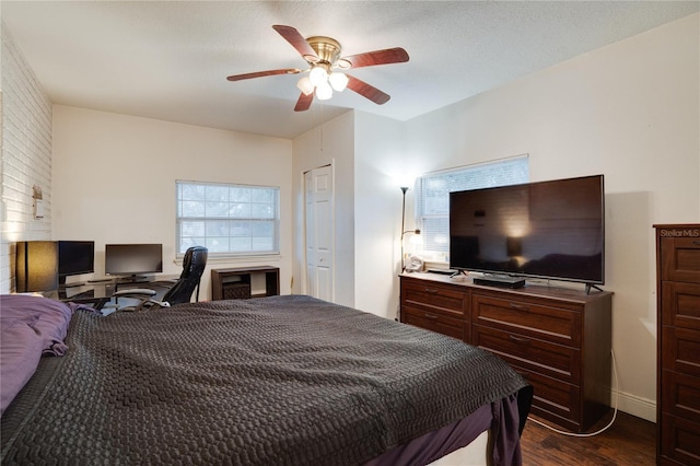 bedroom with ceiling fan and dark wood-type flooring