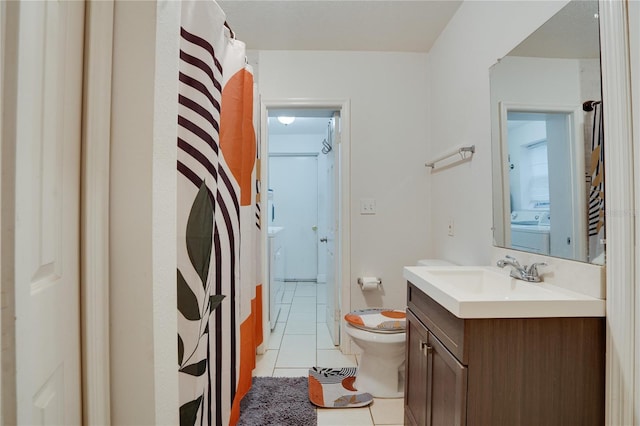 bathroom with toilet, vanity, tile patterned flooring, washer / clothes dryer, and curtained shower