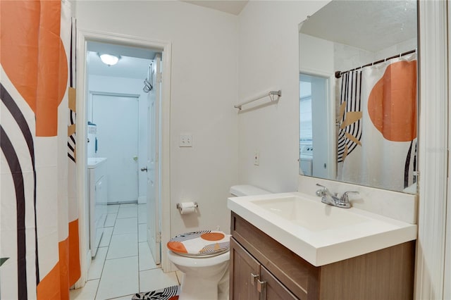 bathroom featuring toilet, vanity, and tile patterned flooring