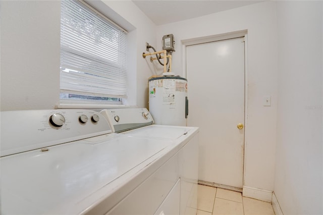 laundry area with electric water heater, light tile patterned floors, and separate washer and dryer
