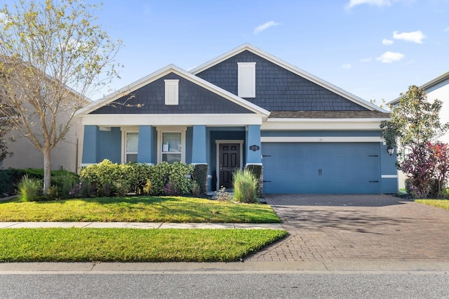 view of front of house featuring a front yard and a garage