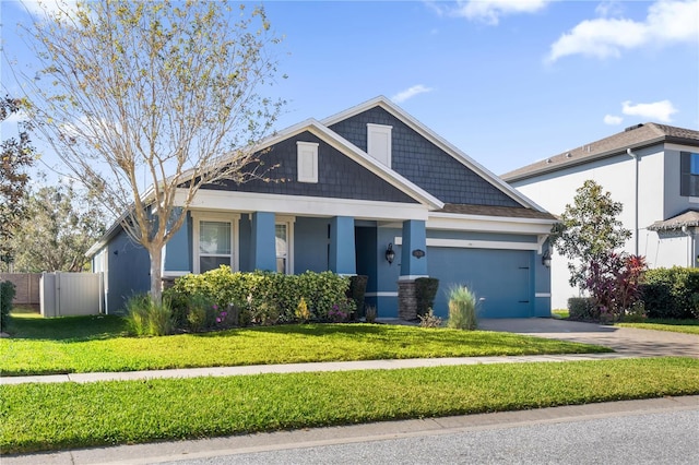 view of front of home with a front yard and a garage