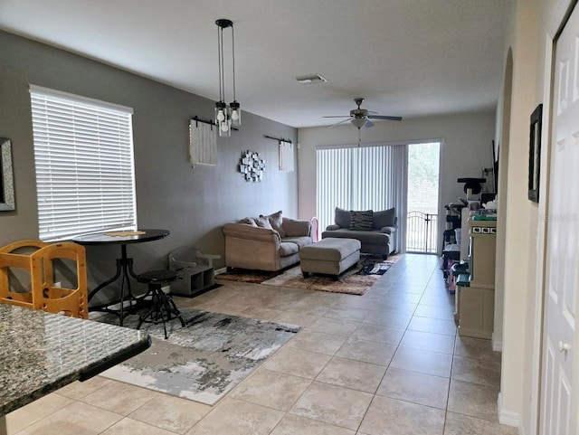 tiled living room featuring ceiling fan