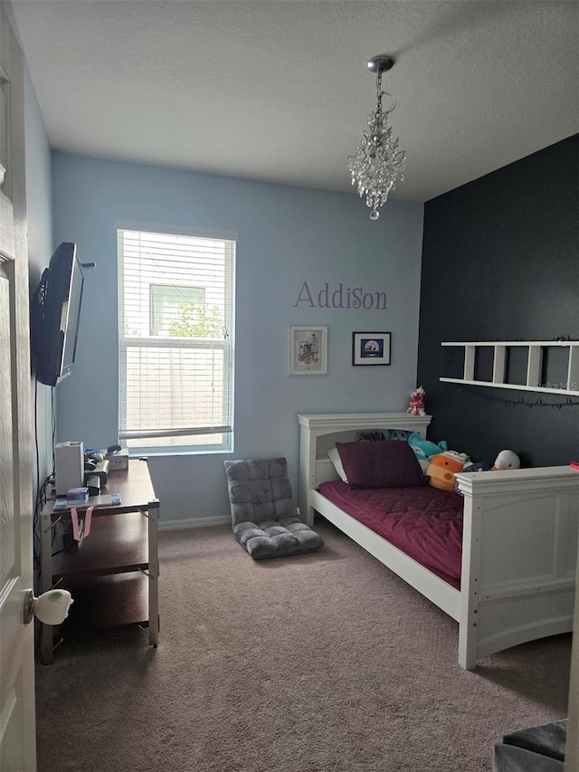 bedroom with an inviting chandelier and carpet flooring