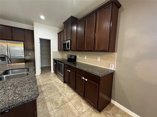 1570 Fox Grape Loop, Lutz, FL 33558 - kitchen with a sink, appliances with stainless steel finishes, dark brown cabinetry, and tasteful backsplash
