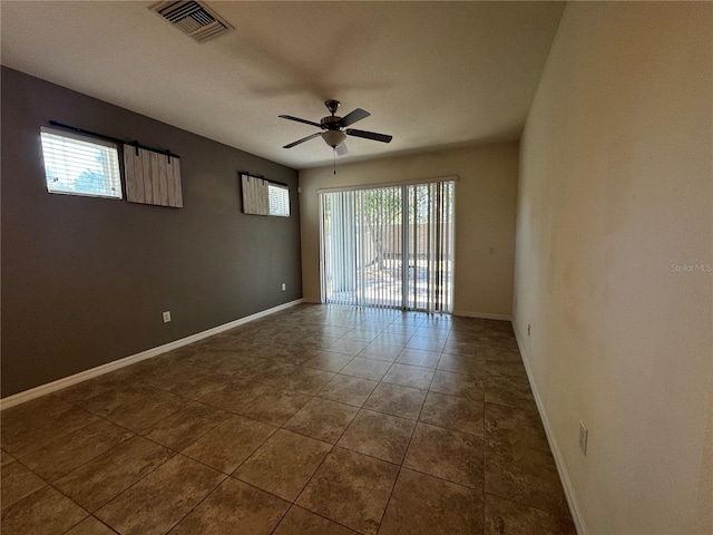 1570 Fox Grape Loop, Lutz, FL 33558 - spare room with visible vents, a ceiling fan, baseboards, and dark tile patterned flooring
