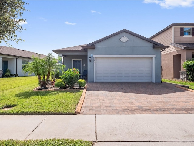 view of front of home with a garage and a front lawn