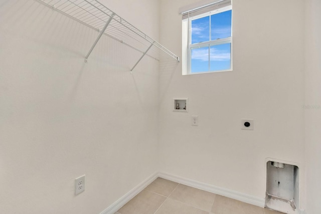 laundry area with washer hookup, electric dryer hookup, and light tile patterned floors