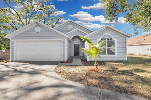 single story home with a garage and a front lawn