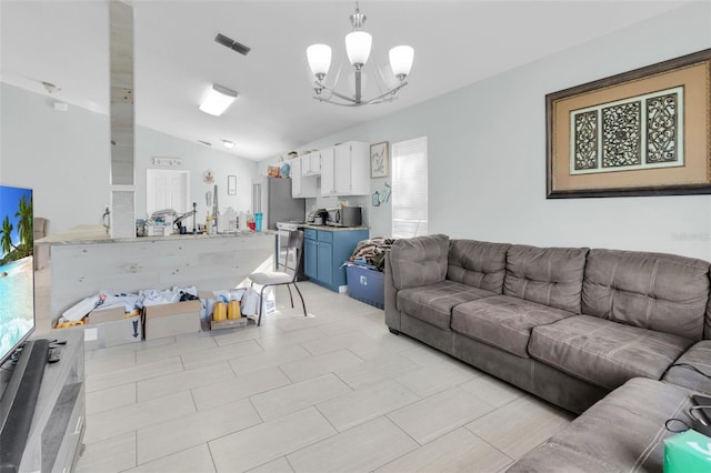 living room featuring a chandelier and vaulted ceiling