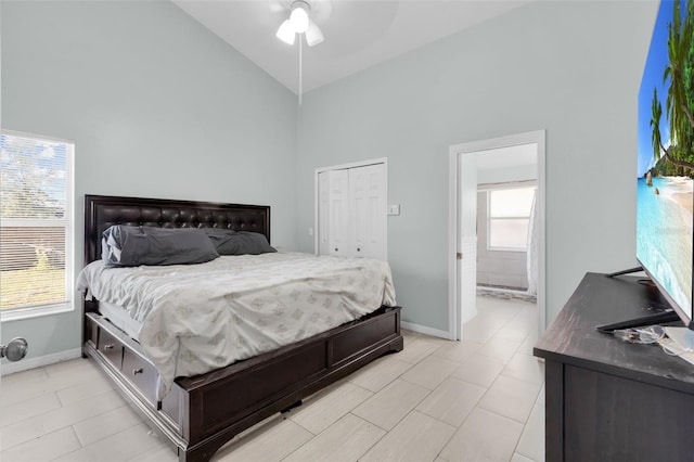 bedroom featuring ceiling fan, high vaulted ceiling, and multiple windows