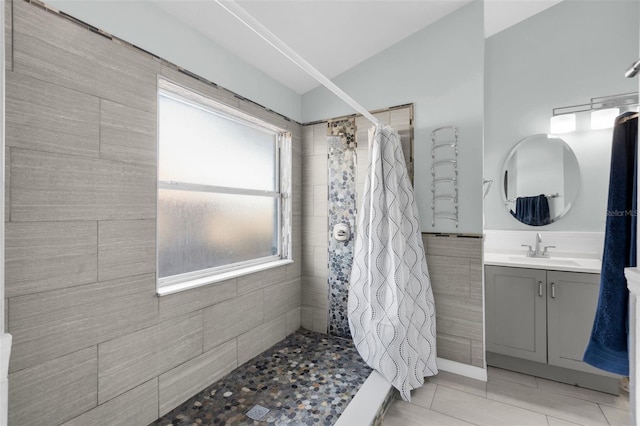 bathroom with a shower with shower curtain, vanity, and tile patterned floors