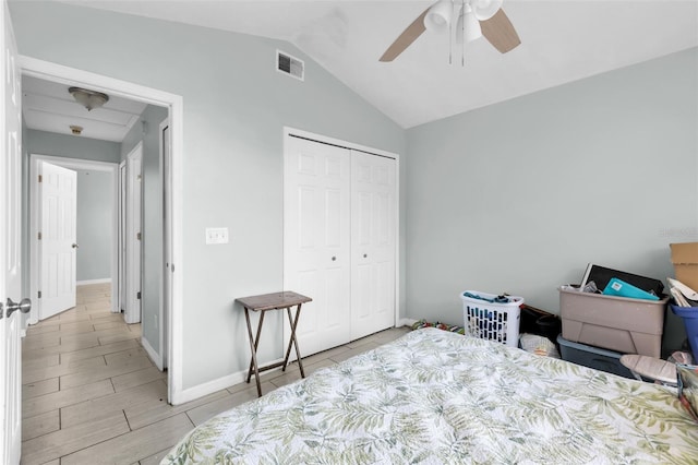 bedroom with ceiling fan, vaulted ceiling, and a closet